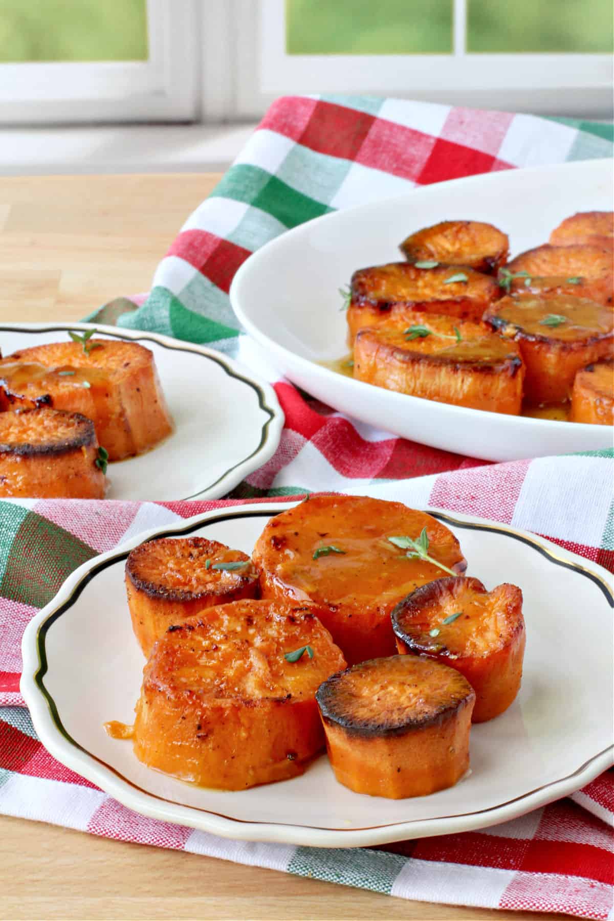 Honey Garlic Sweet Potatoes on individual plates.