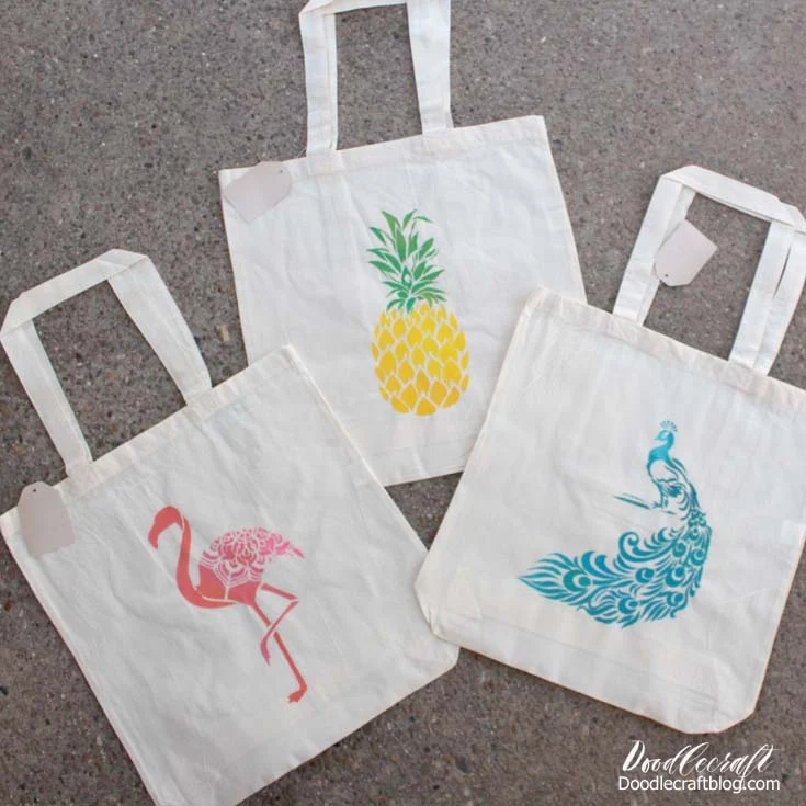 Tropical Tote Bags Summer Camp Craft Get ready for Summer sunshine with these cute tropical vibe tote bags! Need a quick craft for Summer camp or just a fun activity?  Stenciling is the solution!  It's easy and great for a wide range of ages and skill levels.   Stencil Revolution sent me a few stencils to sample and I love them. They make this project simple and successful for any skill level.  I love the tropical vibe. I could live at the beach with my feet in the sand. So I picked some stencils with the beachy vibe to them...plus I love peacocks!