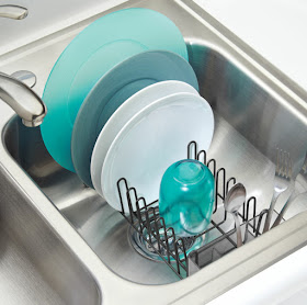 a dish rack sitting in a sink — has slots for plates an a silverware holder up front
