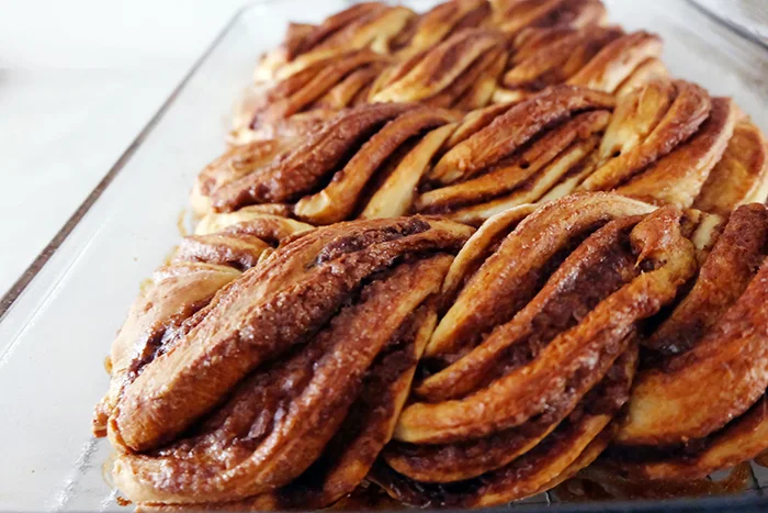 close up view of twisty cinnamon rolls in pan