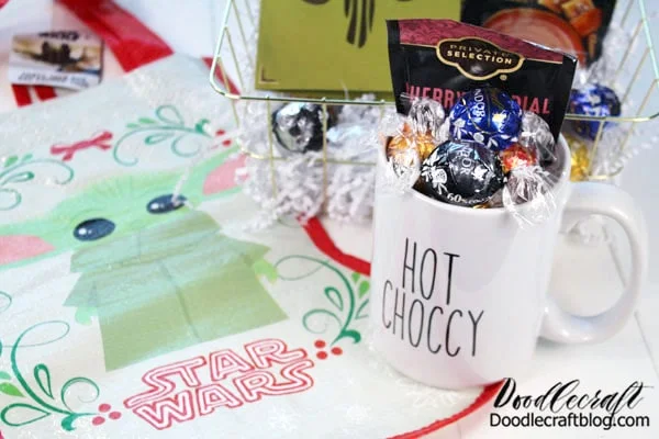 Fill the mug with candy! Write "This is the Way" inside the card! Roll up the baby yoda stocking and stuff them all inside a wire basket from the dollar store.