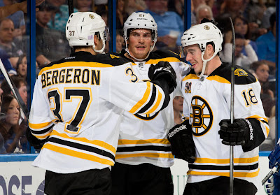 Patrice Bergeron #37 of the Boston Bruins celebrates his goal with teammates Loui Eriksson #21 and Reilly Smith #18