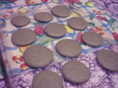 piping macarons onto a baking pan