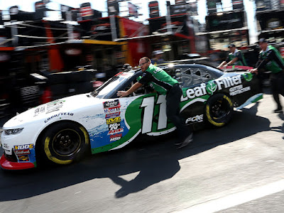 Justin Haley's crew pushes his car through the garage area before qualifying for the NASCAR Xfinity Series Drive for the Cure 250 presented by Blue Cross Blue Shield of North Carolina at Charlotte Motor Speedway.