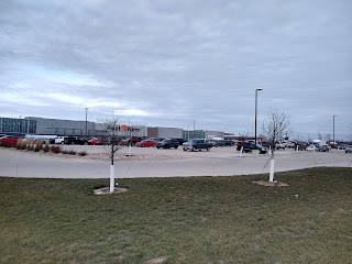 Big-box store with parking lot and some cars