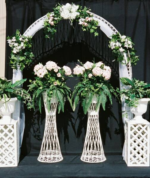 For a more classic look a traditional white arch surrounded by arrangements 