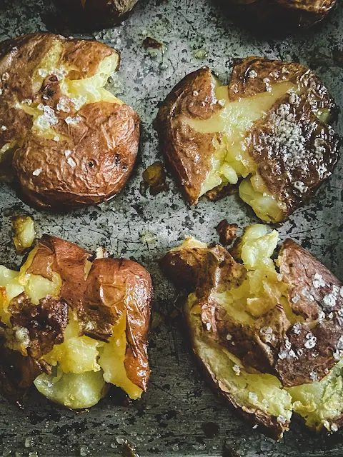 Ultra Crispy Smashed Potatoes, sweet little potatoes crispy on the outside and creamy on the inside with a generous sprinkle of coarse salt.  There is nothing complicated or fussy about them–– just easy.