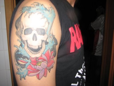 The popular flaming skull tattoo design for men's upper arm Skull tattoos