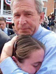 President George W. Bush hugging a grieving young girl.