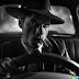 Portrait of a man at steering wheel of a car…