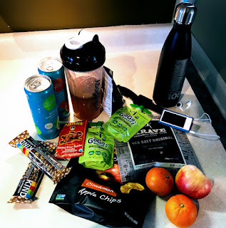 Pack healthy snacks for a Thanksgiving road trip - Shakeology shaker cup and packets, water, fruit, protein and kid-friendly snacks.