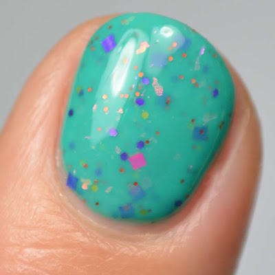 teal crelly nail polish with glitter swatch close up