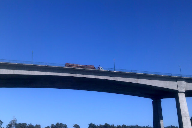 looking up at a truck on a bridge