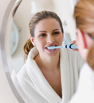 brushing teeth with electric toothbrush