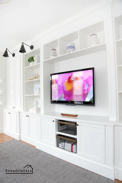 Long wall of built ins around TV