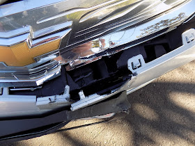 Close up of interior bumper damage on 2017 Chevy Volt before collision repairs at Almost Everything Auto Body.