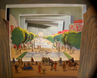 An accordion book showing a scene of people in a park.