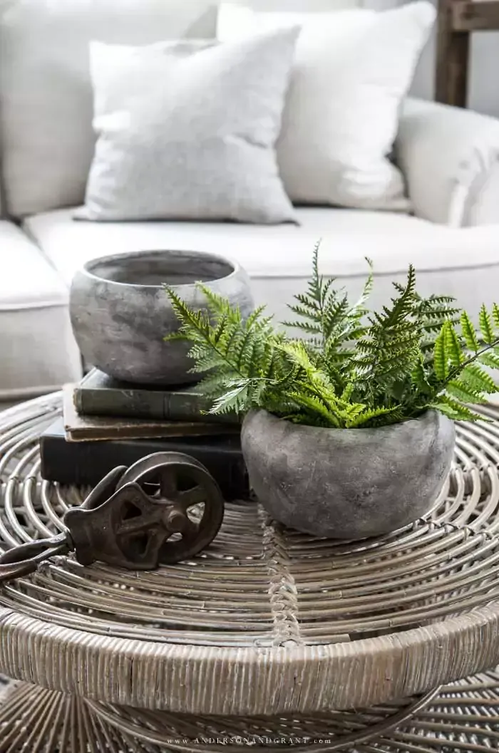 Pair of stone planters on wicker coffee table