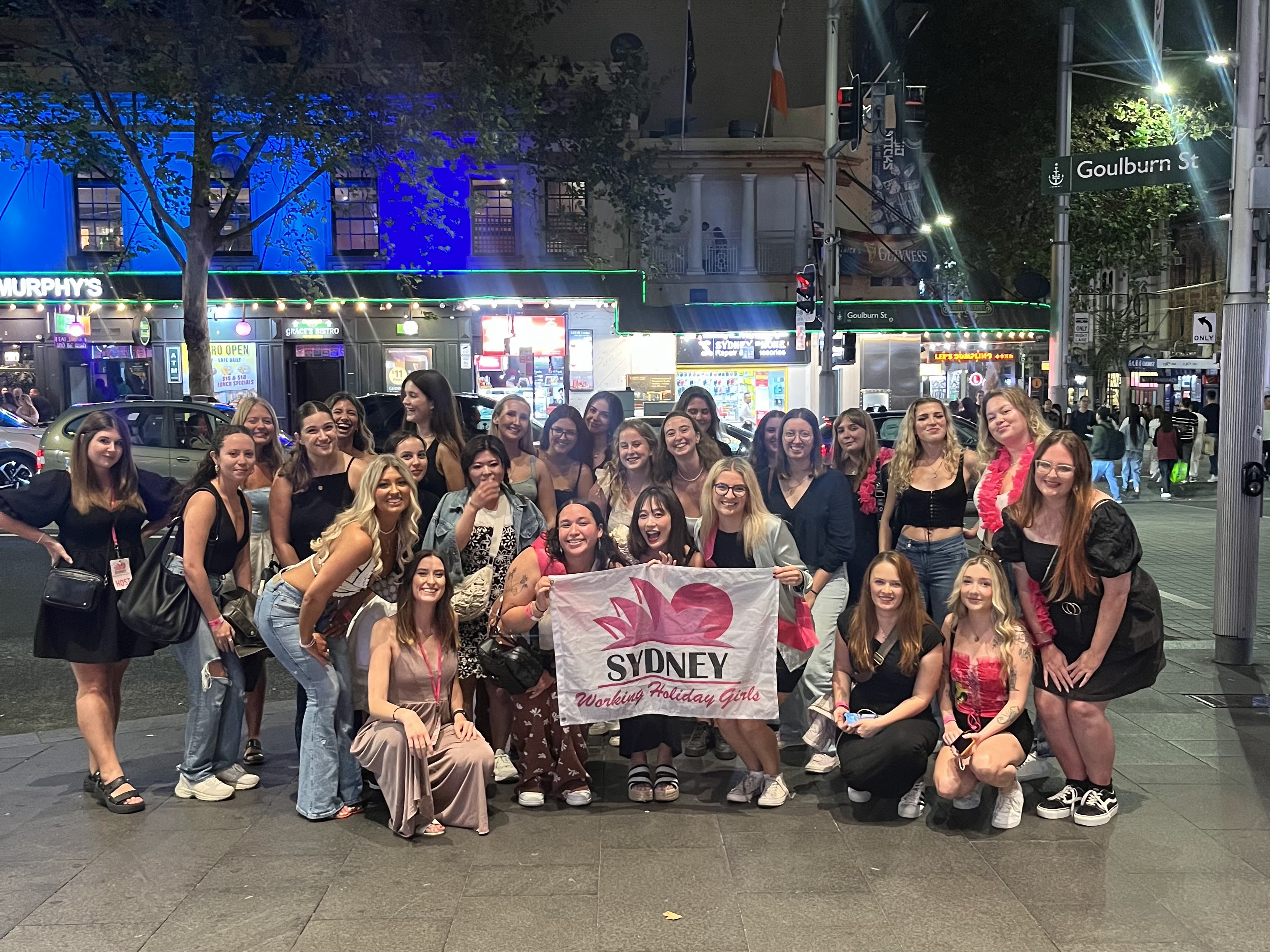 Grace and a group of girls posing for a photo whilst on a girls only bar crawl in Sydney CBD