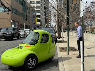 Dr. Mittelman standing next to a green car