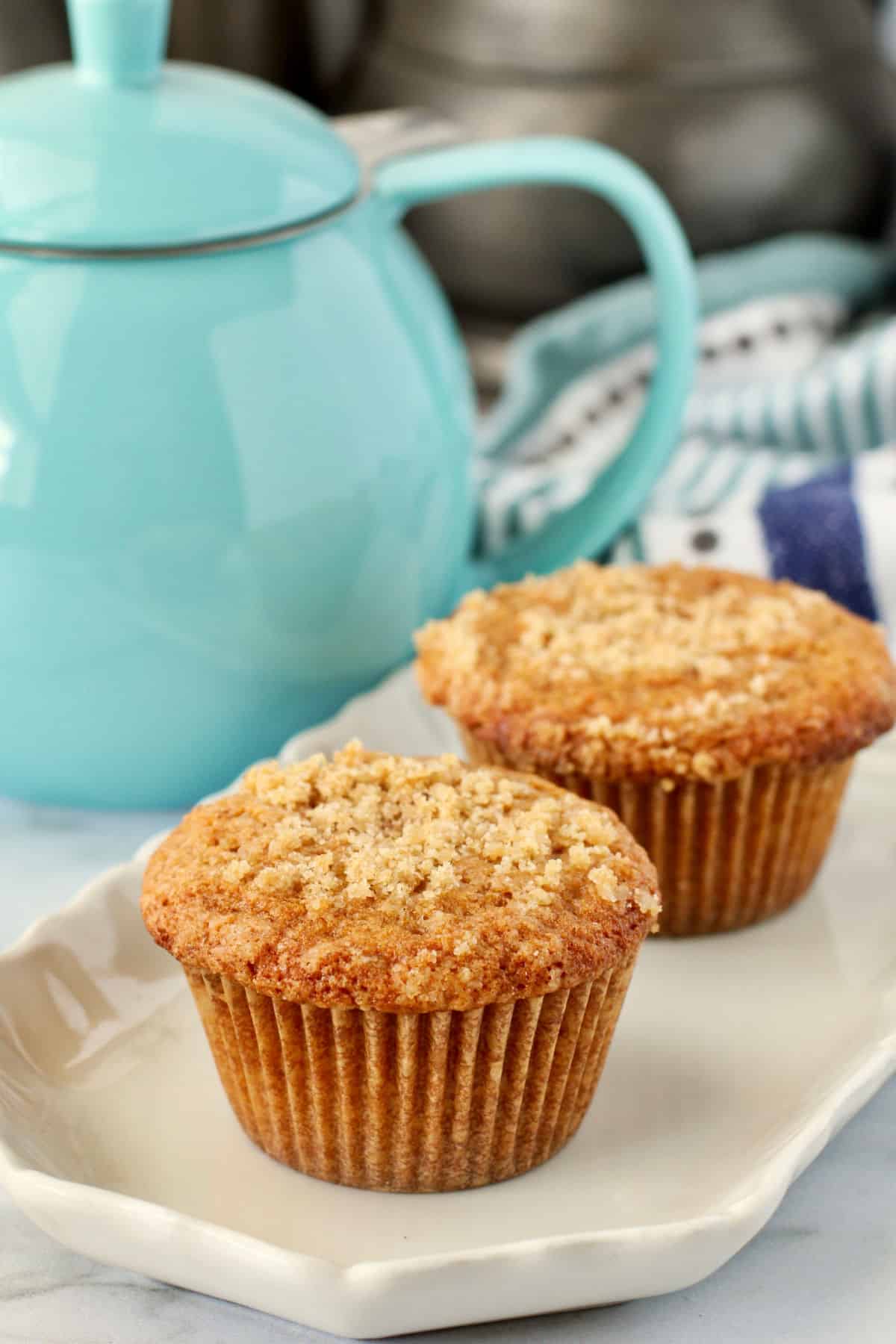 Buttermilk Crumb Muffins with a blue teapot in the background.