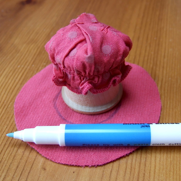 Making the red mushroom fabric cap for the pincushion using soluble fabric marker pen