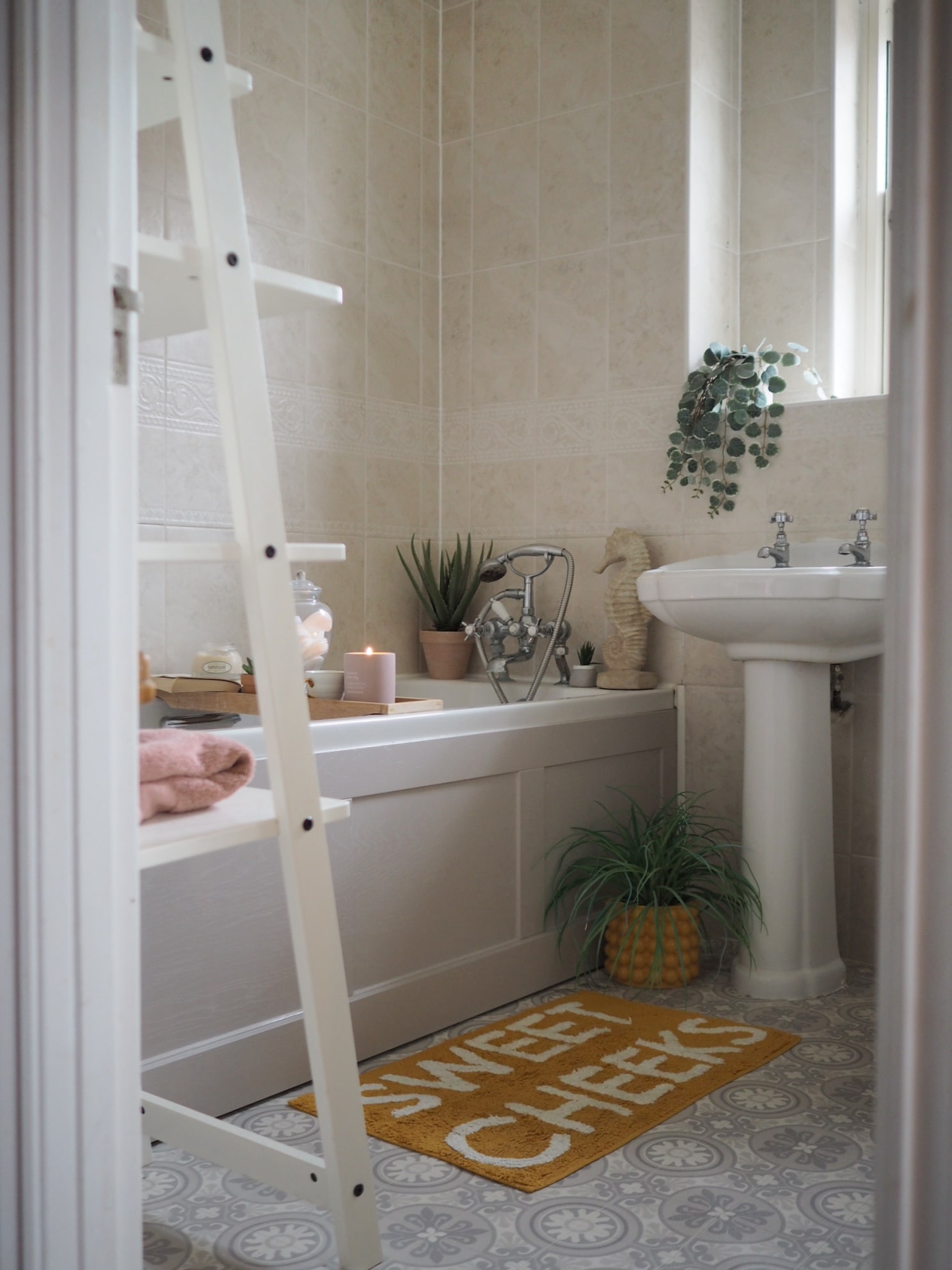 How to update a bathroom on a budget. From painting tiles, to adding new flooring, lighting and stylish storage. Bathroom interior inspiration.