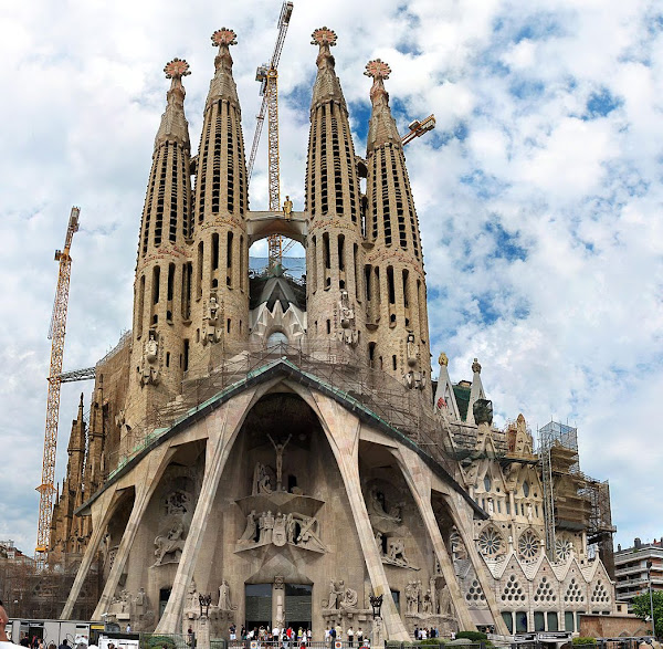 front view of famous Sagrada Familia cathedral on Barcelona with the skies in the background