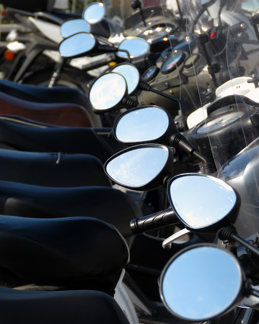 Scooter mirrors reflecting a clear sky, Piazza dell'Arsenale, Livorno