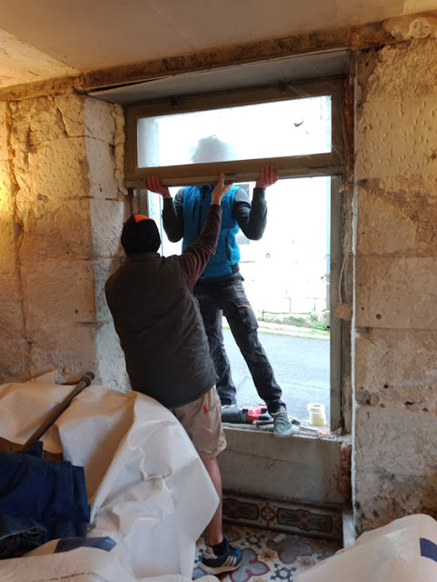 Removing an old window during a renovation, Indre et Loire, France. Photo by Loire Valley Time Travel.
