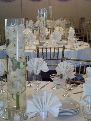 Centerpieces today were tall cylinders with cymbidium orchids under water