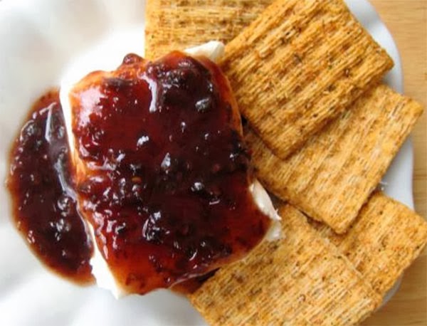 Raspberry Chipotle Cream Cheese Dip: Cream cheese topped with a raspberry chipotle jam served with crackers
