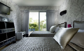 Another bedroom with two beds and silver interior design