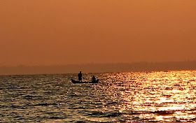 silhouetted boat against the dusky sky