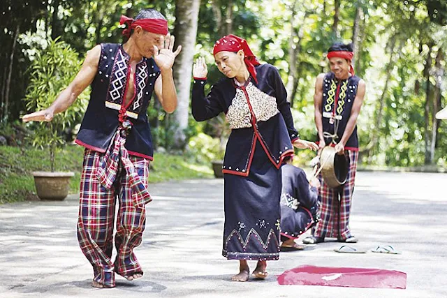 Subanon performing a traditional dance to the beat of a brass gong,