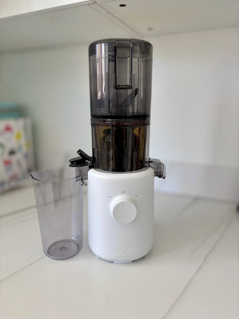 Hurom H310 Compact Juicer in White Sits on Kitchen Counter