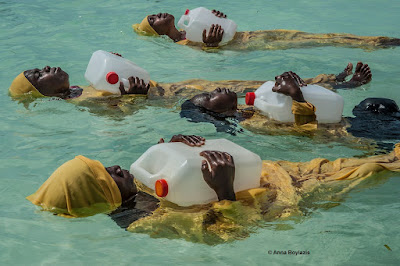 © Anna Boyiazis color photograph of young women learning to swim in  Indian Ocean off of Muyuni, Zanzibar