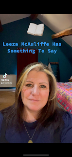 I'm sitting in a bedroom office, with a bed behind me. I look serious. There is a caption above my head that says, 'Leeza McAuliffe Has Something To Say.
