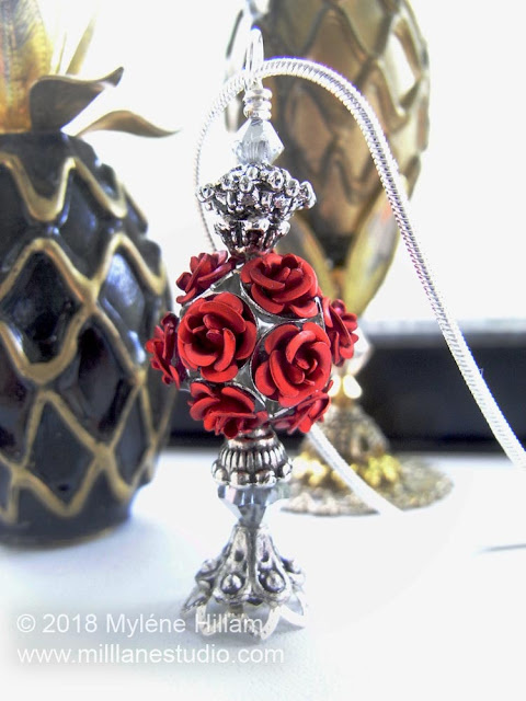 Rose bottle pendant featuring a red rose cluster bead, bead caps and silver Swarovski crystals