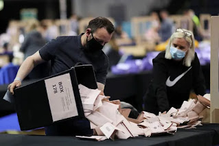 member of the electoral staff counts the votes for the Scottish General Election on May 8, 2021
