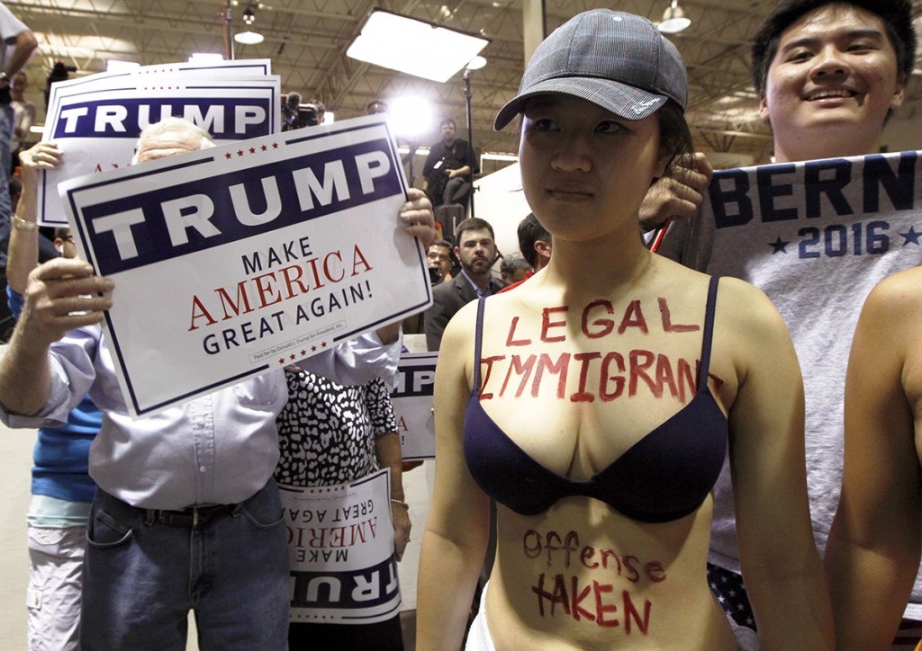 70 Of The Most Touching Photos Taken In 2015 - A protester stands outside a Donald Trump rally in Norcross, Georgia.