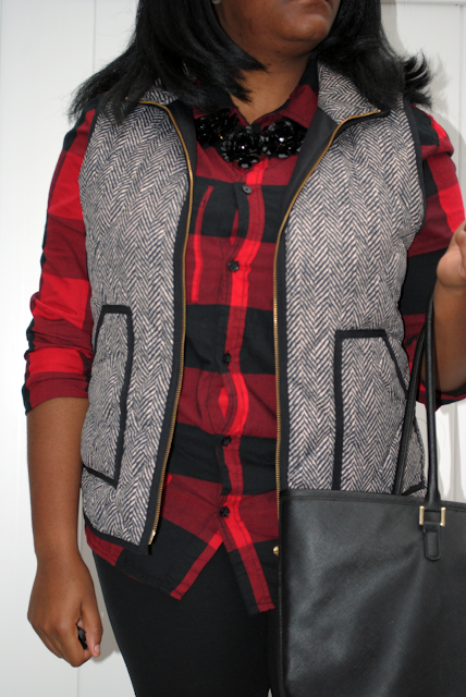 A holiday outfit inspiration post featuring a buffalo plaid shirt, herringbone vest, black pants and black booties.