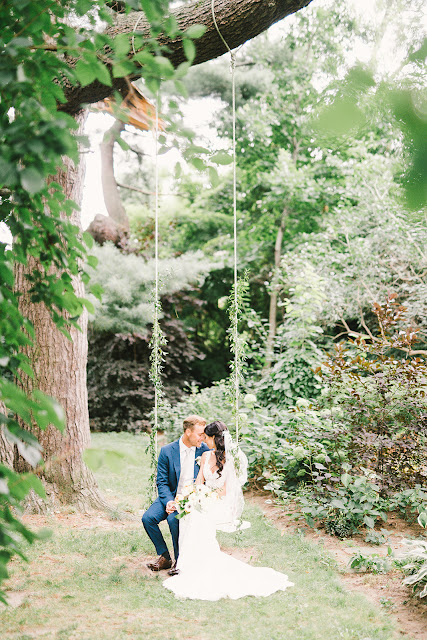 Niagara Wedding Planner | A Divine Affair | Sara and Daniel - Photo by Julia Park Photography. Ceremony and Reception at Kurtz Orchards Gracewood Estates. Ceremony under a chiffon and floral draped tree. Reception in a tent with live edge wooden harvest tables. 