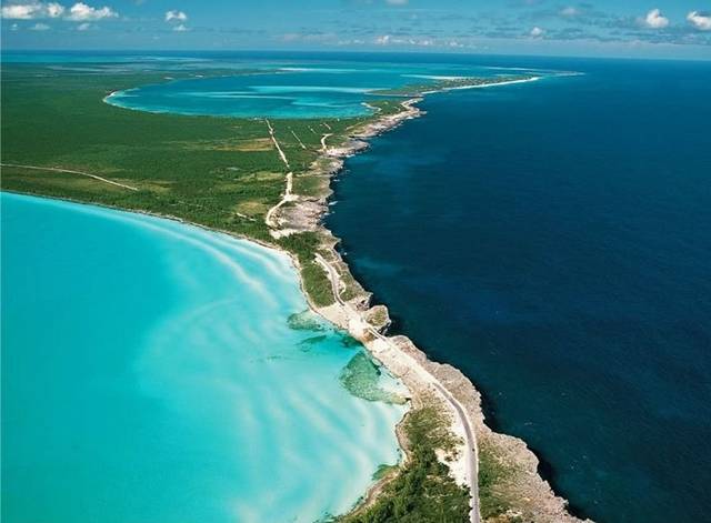 Eleuthera is one of several islands that lies within the archipelago in The Bahamas, about 80 km east of the capital city Nassau. It is long – about 180 km – and thin - only about 1.6 km wide in places. The light blue waters of the shallow Caribbean Sea on one side of the island stand out in stark contrast to the deep blue of the Atlantic Ocean thousands of feet in depth. One of the best places to see this extraordinary juxtaposition is at the Glass Window Bridge.