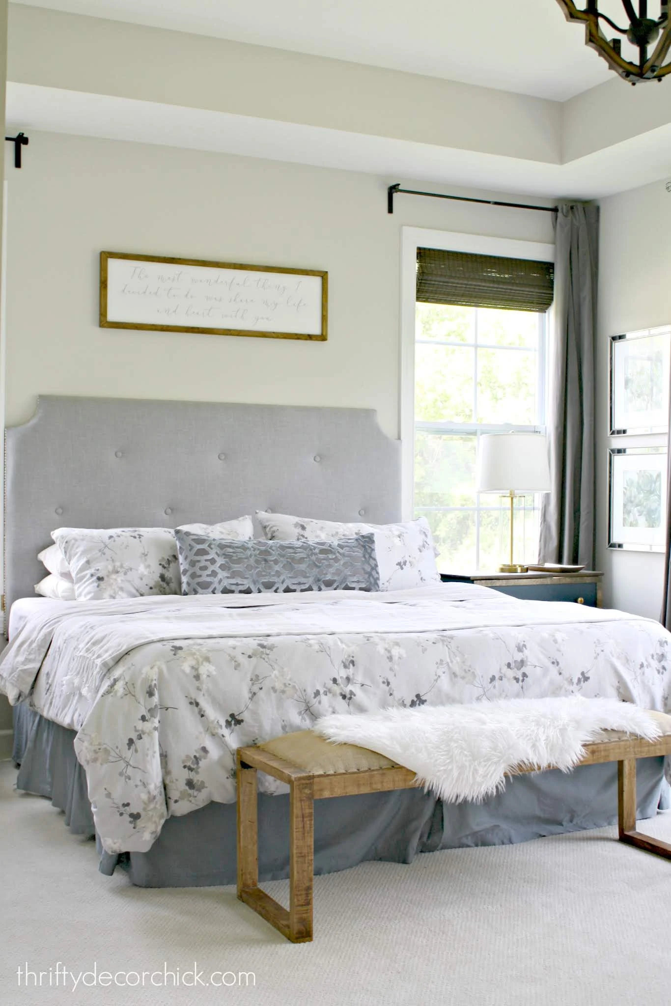 Master bedroom with tufted headboard and art over bed