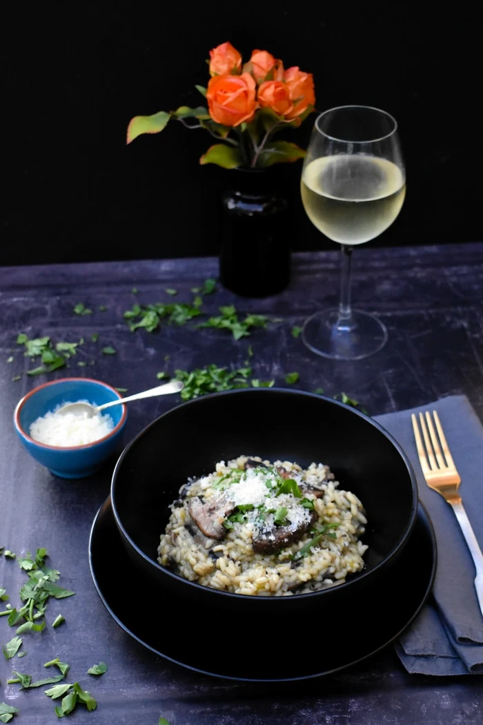 Creamy Mushroom and Leek Risotto topped with vegan style parmesan and fresh parsley