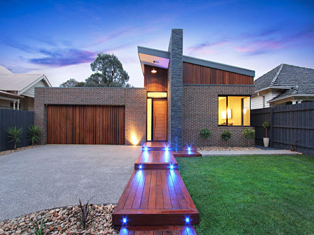 Picture of small contemporary home with wooden walkway to the entrance