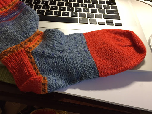 Bright blue, red, and orange hand knit sock