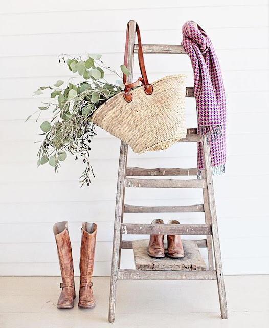 Ladder with French market basket and riding boots in romantic Farmhouse Christmas vignette