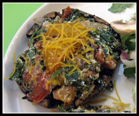 spinach and cheese stuffed into a portobello mushroom cap in a bowl